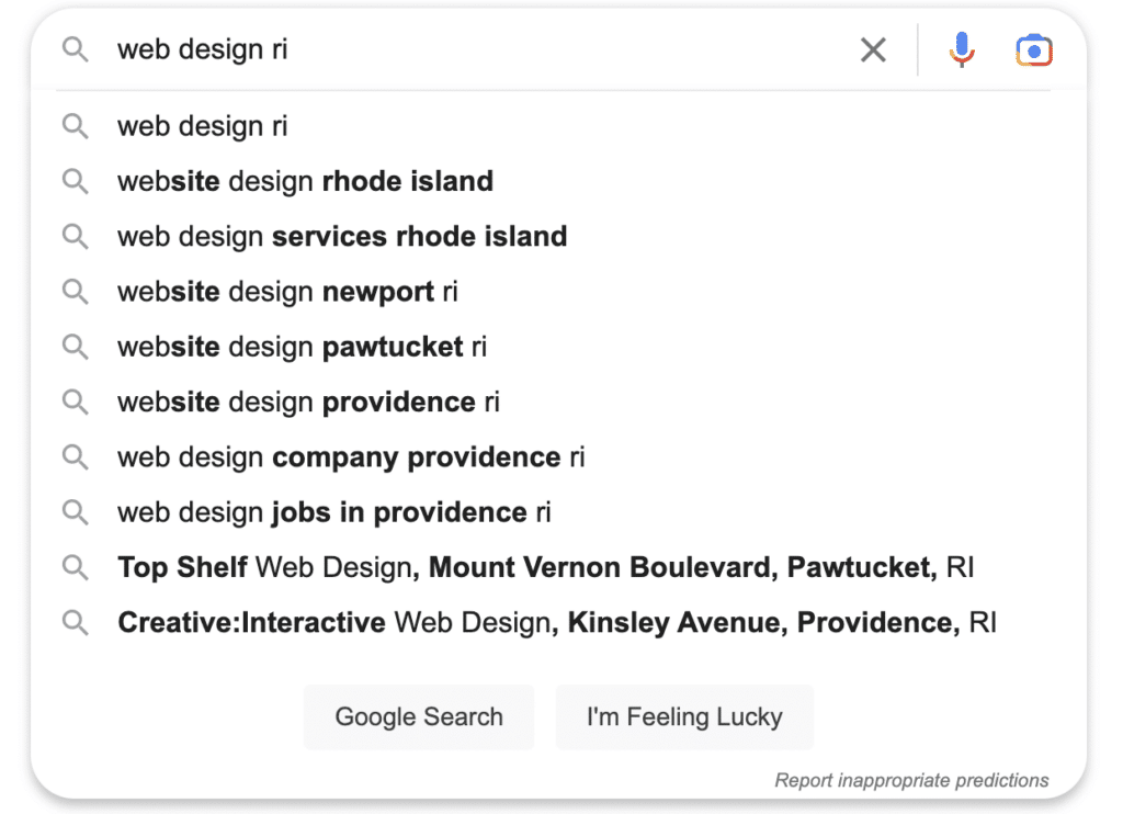Screenshot of typing "web design RI" into the google search page with google's smart suggestions. 